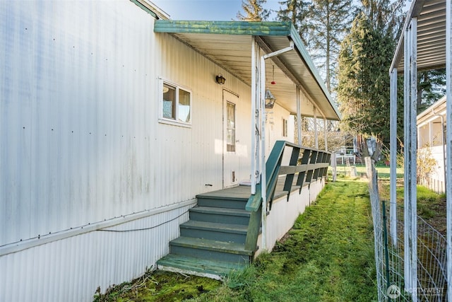 doorway to property featuring a lawn