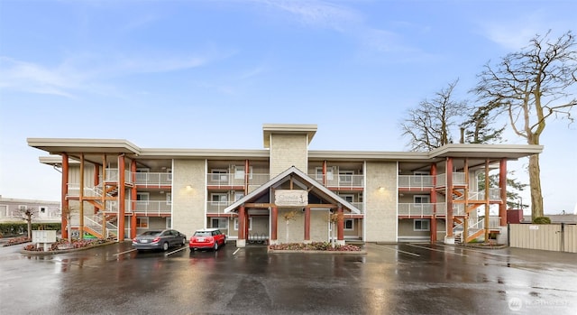 view of property featuring uncovered parking