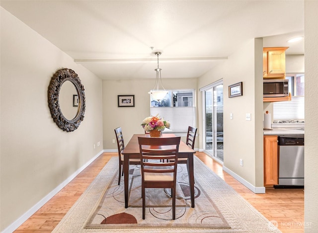 dining area featuring baseboards and light wood-style floors