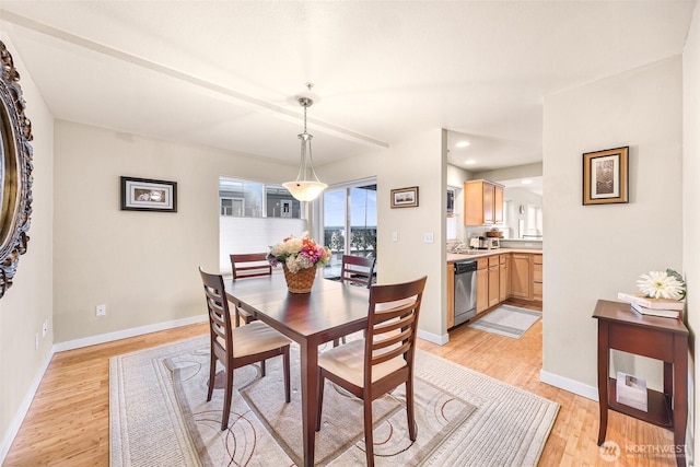 dining space with light wood finished floors, recessed lighting, and baseboards