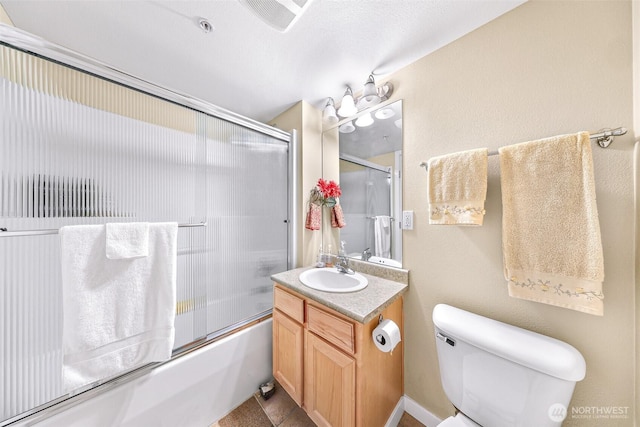 full bath featuring visible vents, bath / shower combo with glass door, vanity, and toilet