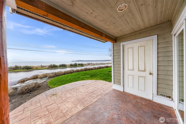 view of patio with a water view