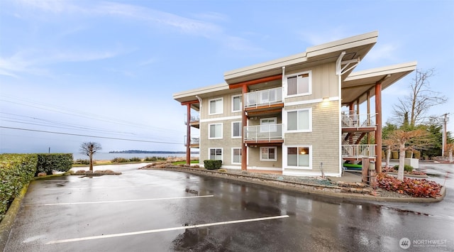 view of building exterior featuring uncovered parking