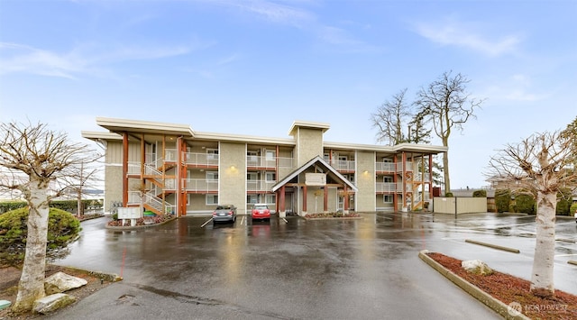 view of building exterior with uncovered parking