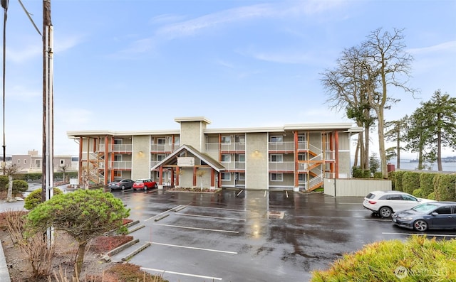 view of building exterior with uncovered parking