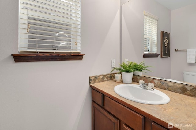 bathroom with vanity and toilet