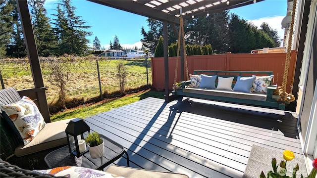 wooden terrace with outdoor lounge area, a fenced backyard, and a pergola