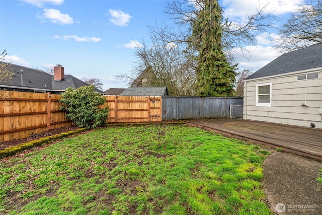 view of yard with a deck and fence