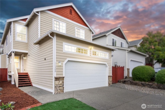 view of front of house featuring stone siding and driveway