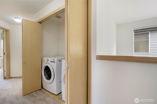 washroom with laundry area, light colored carpet, and washer and clothes dryer