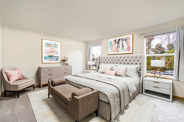 bedroom with light carpet and baseboards