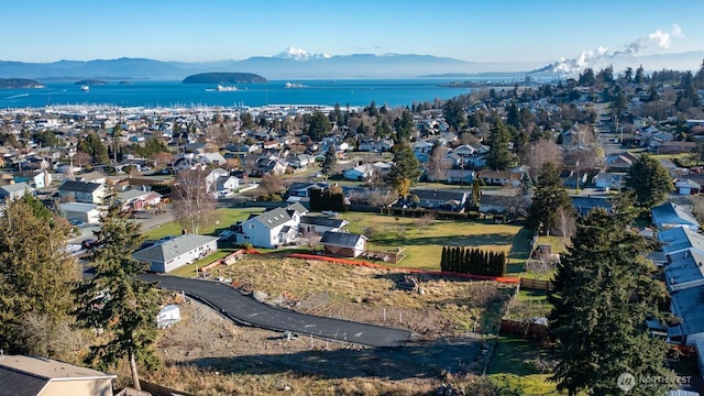 birds eye view of property featuring a residential view and a water and mountain view