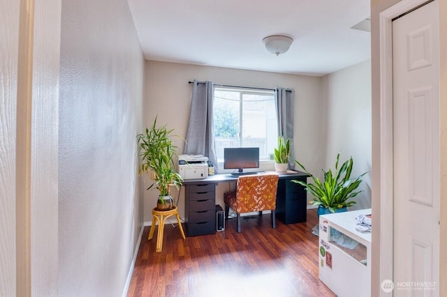 office space with wood finished floors and baseboards