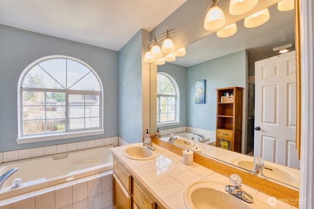 full bathroom with a garden tub, double vanity, and a sink