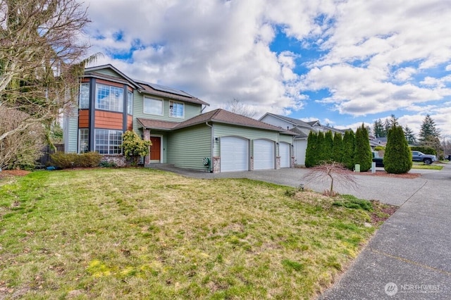 view of front of house with solar panels, a front lawn, a garage, and driveway