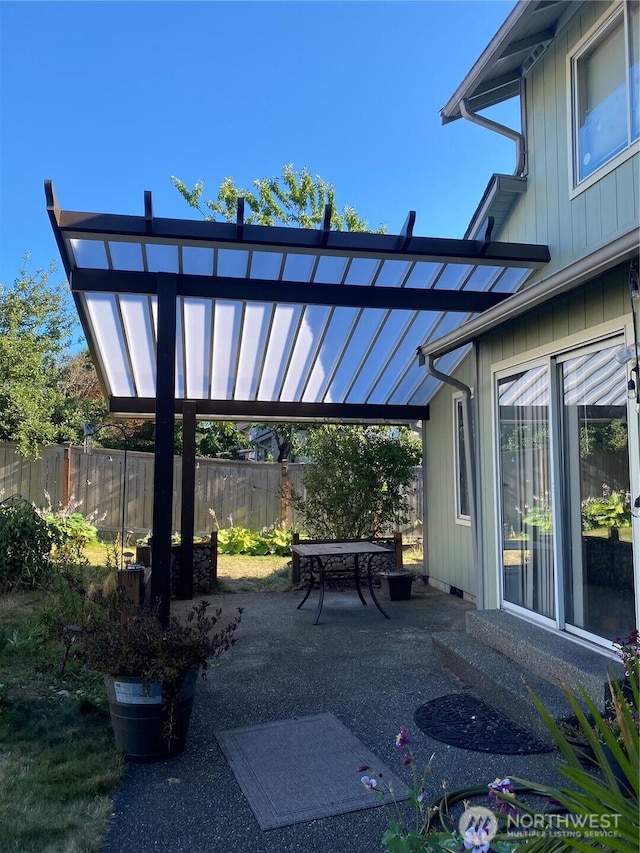 view of patio / terrace featuring outdoor dining space, a pergola, and fence