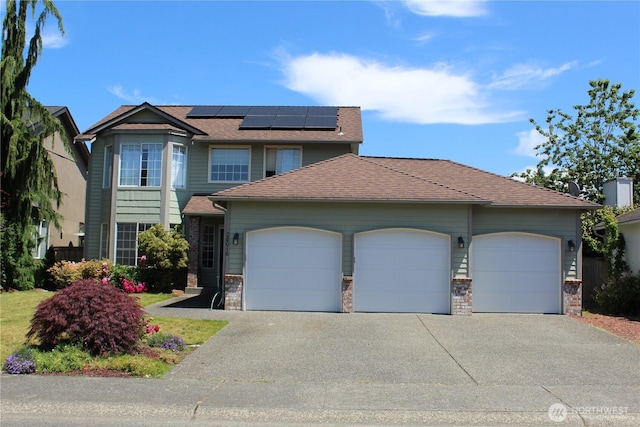 28016 234th Ave SE, Maple Valley, WA 98038 - view of front of home with a garage, driveway, roof mounted solar panels, and roof with shingles