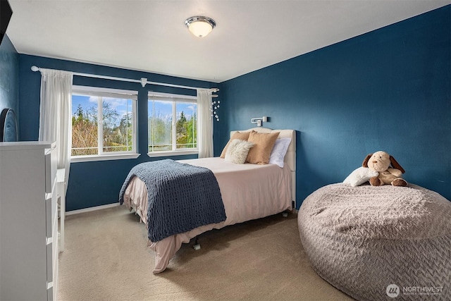 carpeted bedroom with baseboards