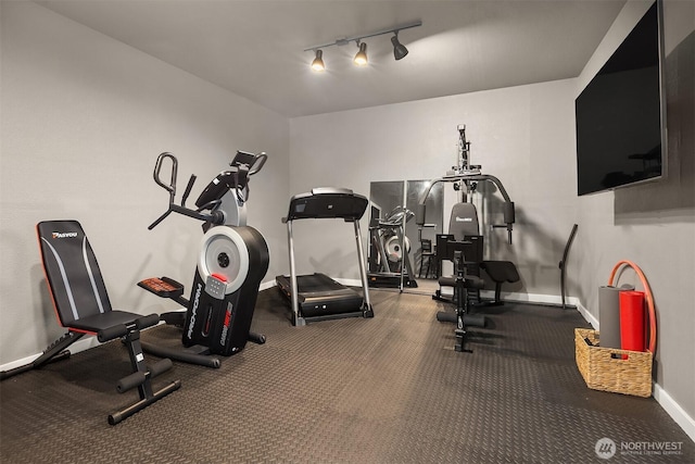 exercise area with baseboards and track lighting