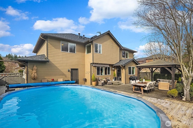 view of pool with an outdoor living space, a fenced in pool, fence, a gazebo, and area for grilling