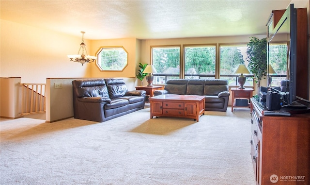 carpeted living area featuring a wealth of natural light, a textured ceiling, and a chandelier