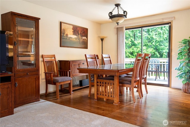 dining space with wood finished floors