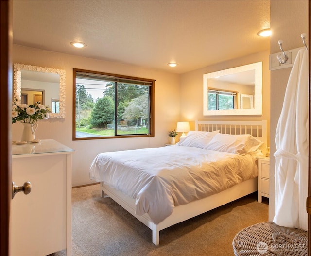 carpeted bedroom with recessed lighting