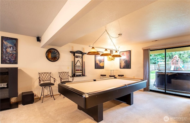 recreation room with a textured ceiling, pool table, and light carpet