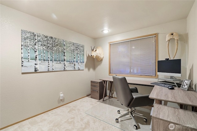 carpeted office featuring baseboards