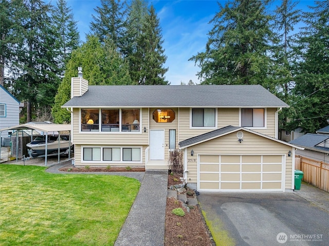 bi-level home featuring a front lawn, fence, driveway, and a chimney