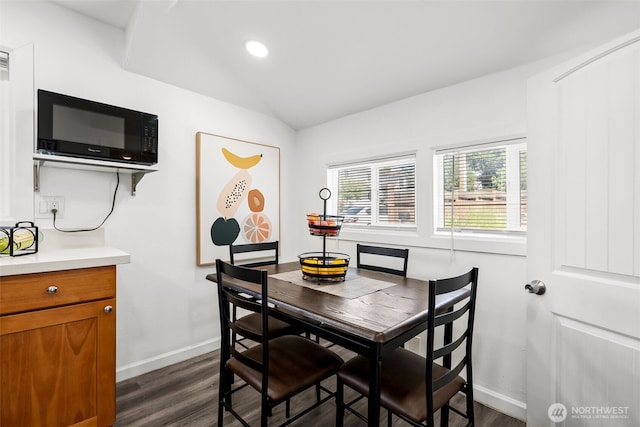 dining room featuring recessed lighting, baseboards, lofted ceiling, and dark wood-style flooring