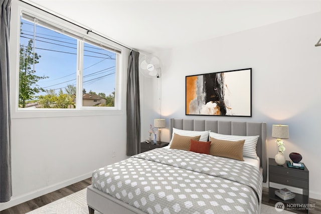 bedroom featuring wood finished floors and baseboards