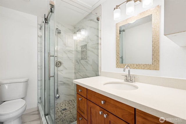 bathroom featuring vanity, toilet, marble finish floor, and a marble finish shower