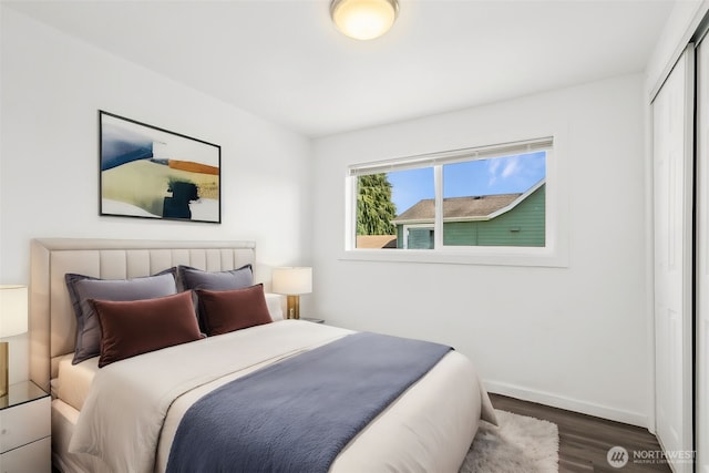 bedroom featuring a closet, baseboards, and wood finished floors