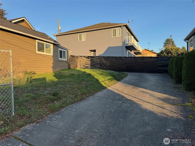 view of side of property with a yard and fence