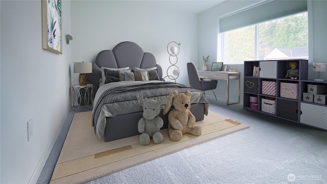 carpeted bedroom featuring baseboards