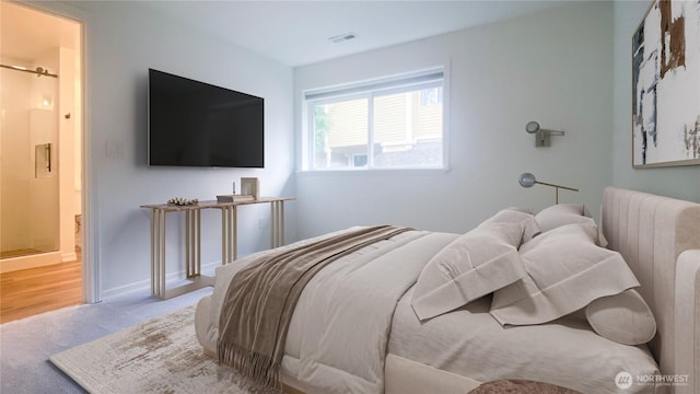 carpeted bedroom with visible vents and baseboards