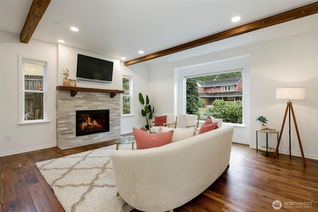 living area featuring a tiled fireplace, dark wood-type flooring, beamed ceiling, and recessed lighting