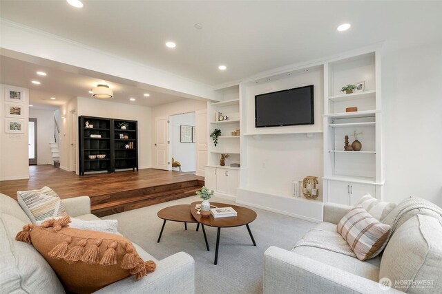 living area with recessed lighting, baseboards, built in features, and wood finished floors