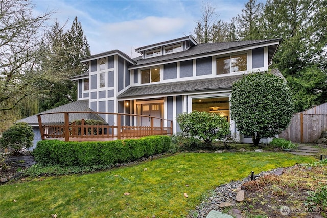 view of front of house featuring a front yard, fence, and stucco siding