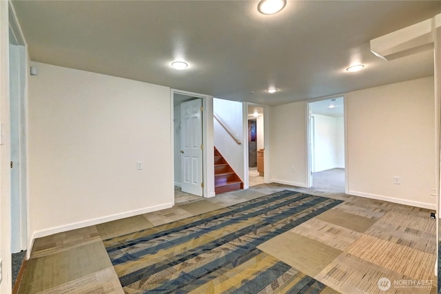 finished basement with stairs and baseboards