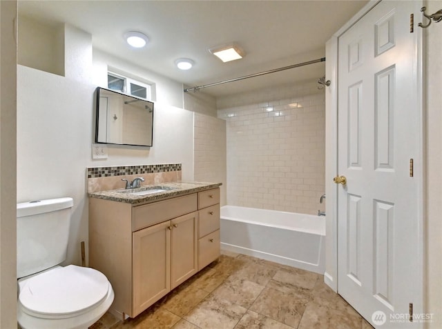 bathroom featuring tasteful backsplash, vanity, toilet, and shower / bathing tub combination