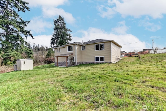 back of house with a storage unit, an outbuilding, and a yard