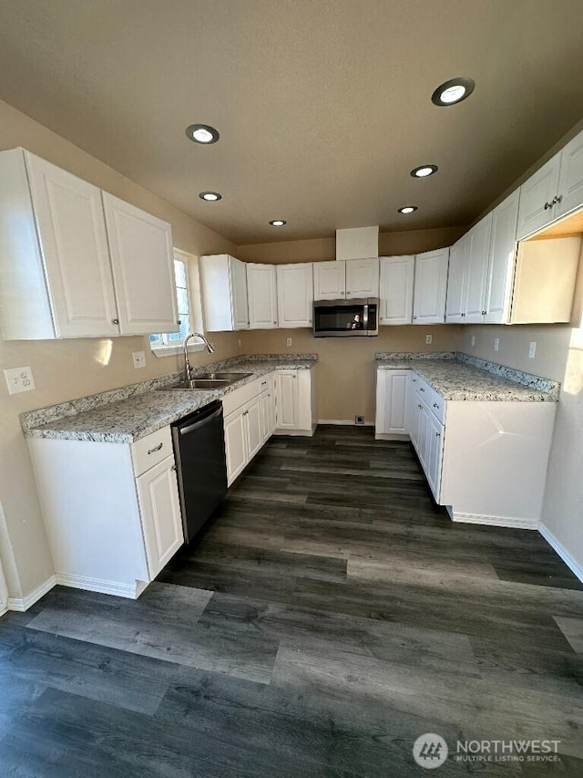 kitchen with dishwasher, stainless steel microwave, dark wood-style floors, and a sink