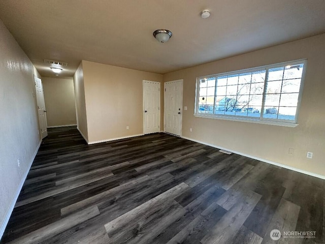 interior space featuring dark wood-style floors and baseboards