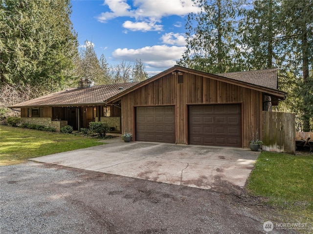 view of front facade with a front yard, an attached garage, and driveway