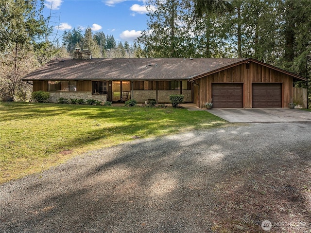 view of front of home with aphalt driveway, an attached garage, and a front lawn