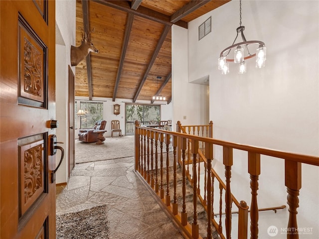 hall featuring visible vents, high vaulted ceiling, wooden ceiling, beamed ceiling, and an upstairs landing