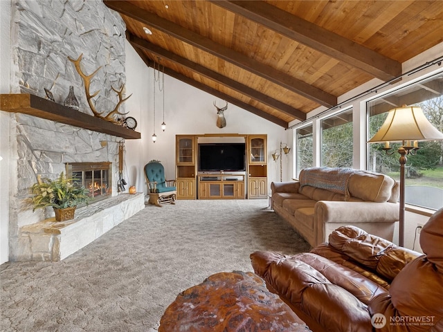 carpeted living area featuring wood ceiling, beamed ceiling, high vaulted ceiling, and a stone fireplace