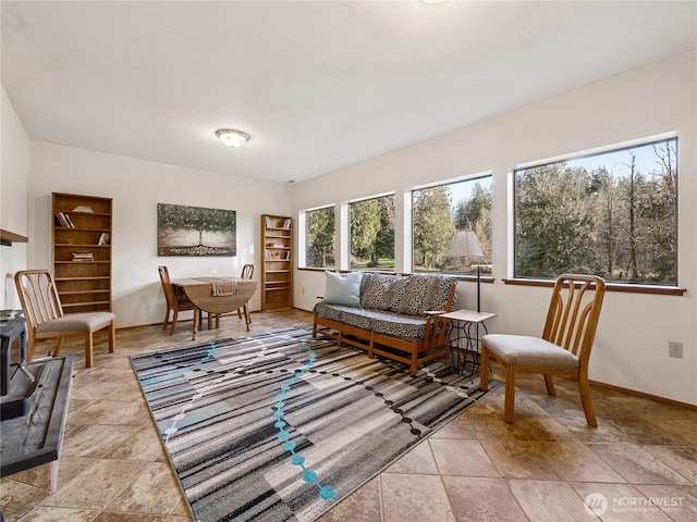 living area featuring baseboards